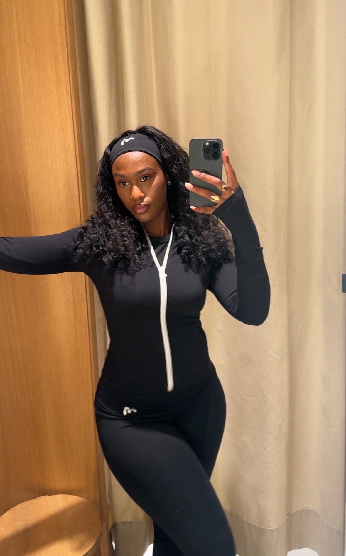 A woman in teal green loungewear outfit with long braided hair.